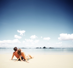 honeymoon_couple_relaxing_on_tropical_beach-01.jpg